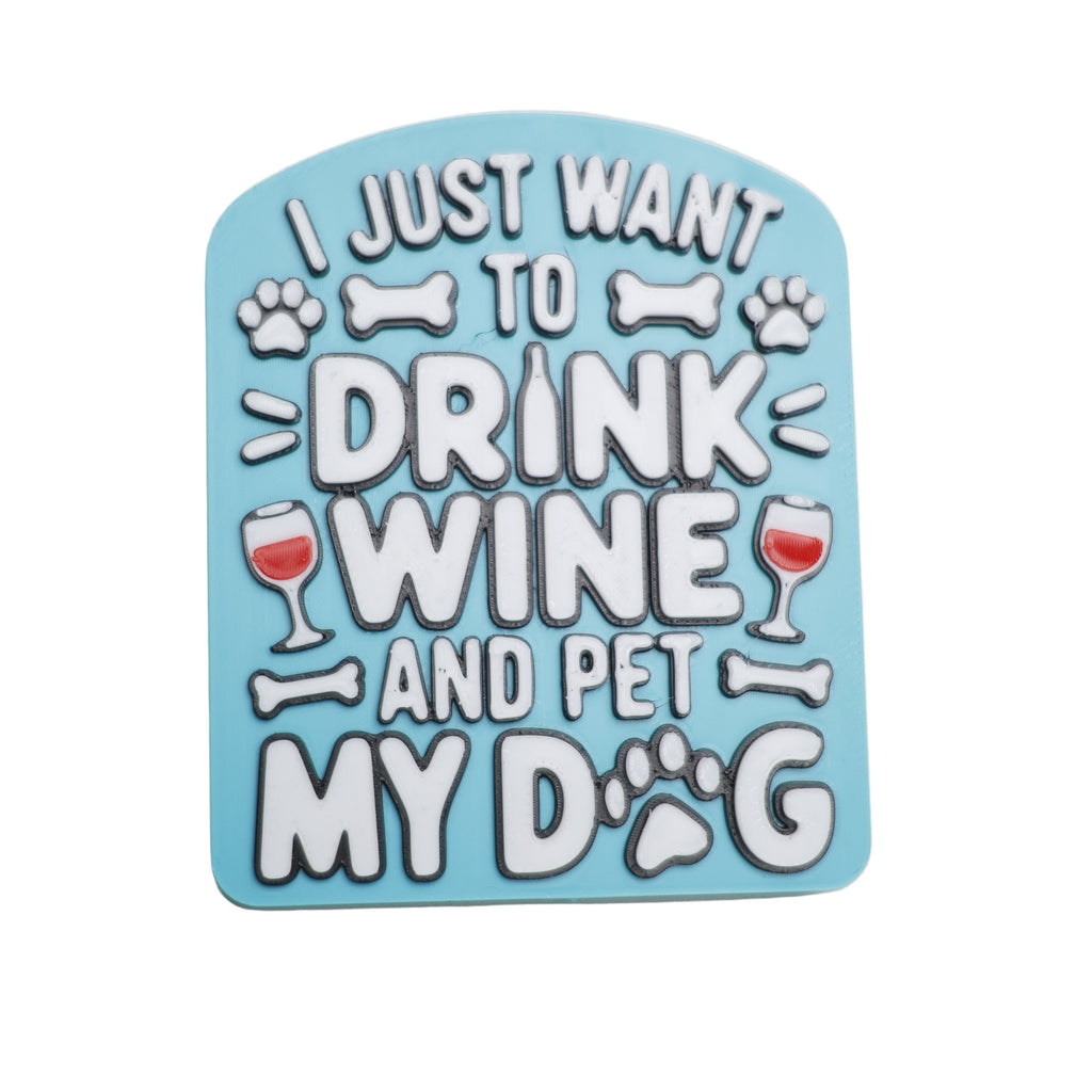 Blue coaster with text 'Just want to drink wine and pet my dog' on a light gray background